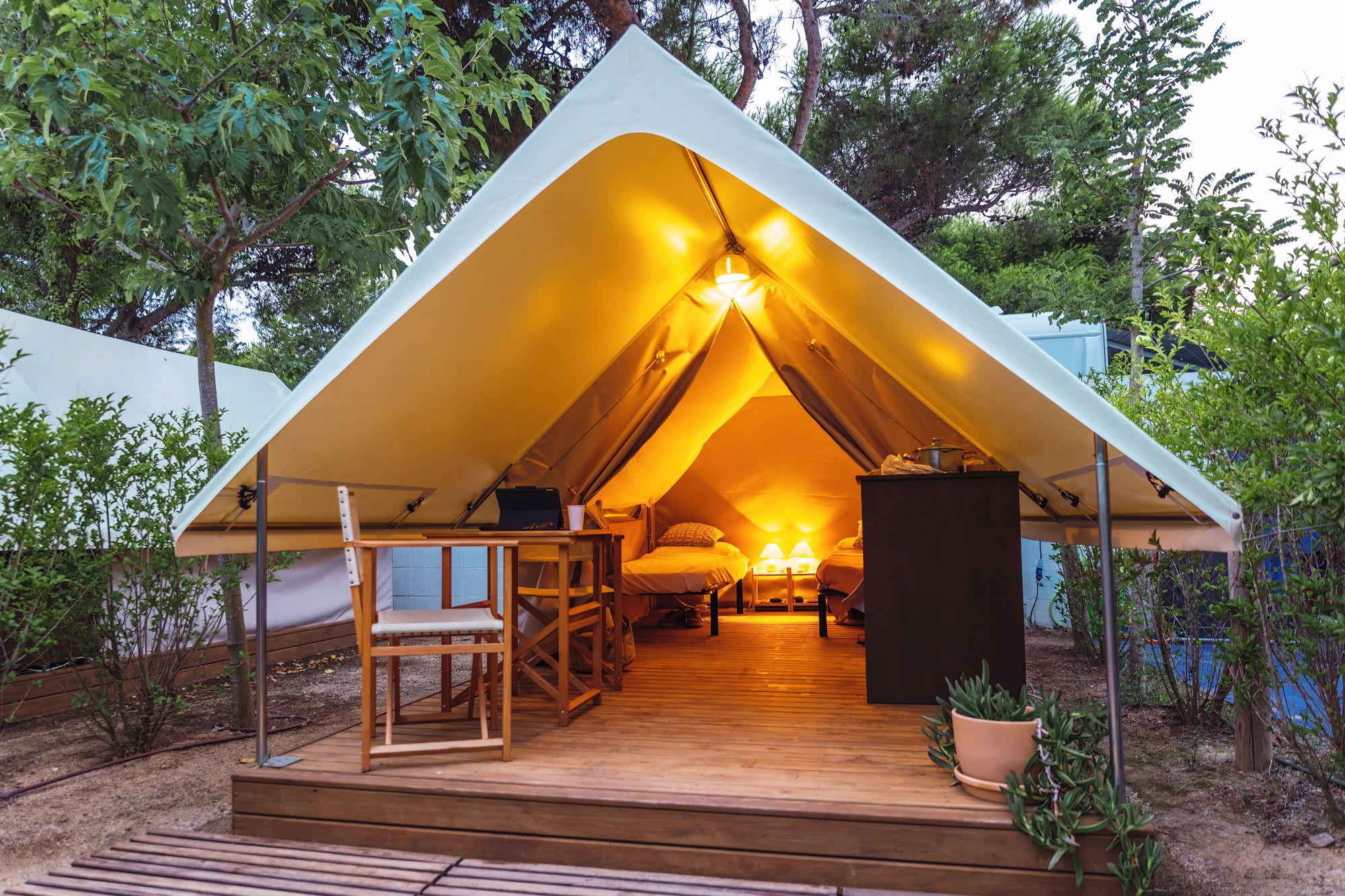 cozy-open-glamping-tent-with-light-inside-during-dusk-luxury-camping-tent.jpg